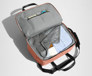 Main interior packed with clothing. Slip pockets packed with a notebook and charging cords