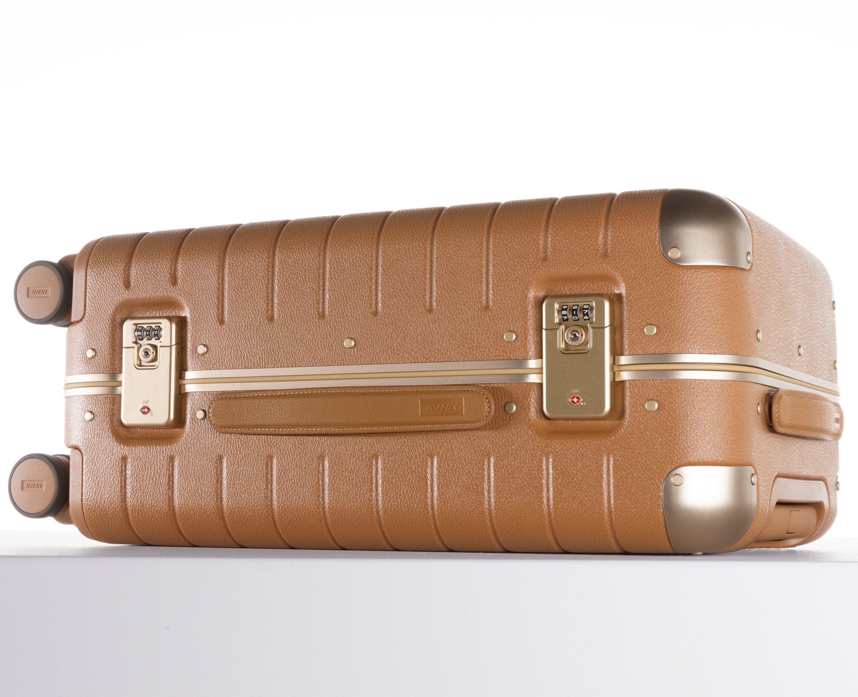 Brown suitcase with gold accents on a white background
