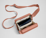 The Mini Crossbody packed with a phone, passport, and sunglasses