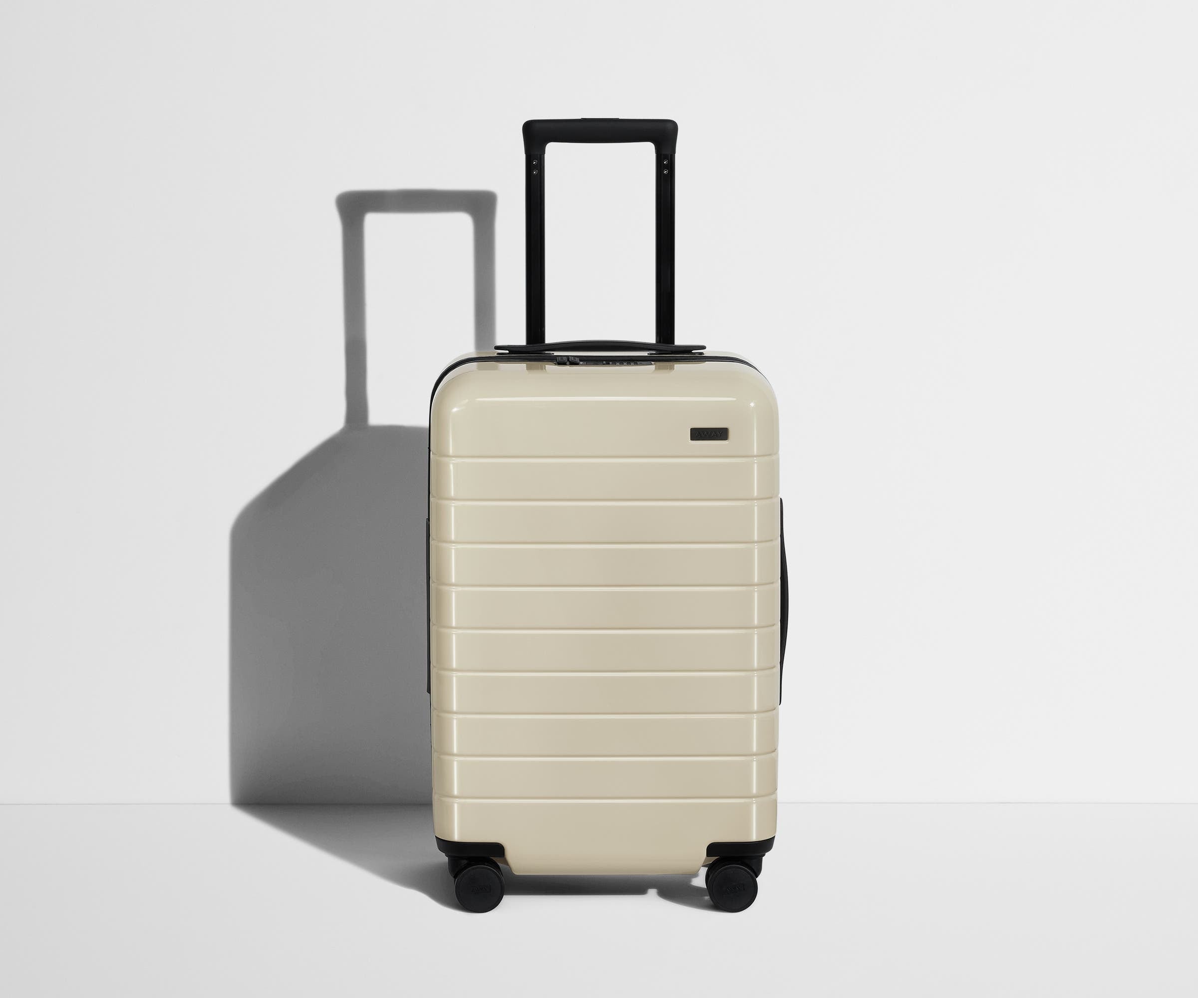 Front product view of The Carry-On suitcase in Coast Blue with raised handle