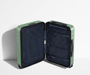 The Carry-On suitcase in Sea Green shown open in an upright position to show interior organization and compression system