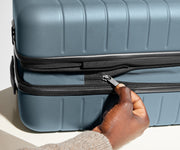 The Bigger Carry-On Flex suitcase in Coast Blue has an additional wraparound zipper to expand the suitcase 2.25" (6 cm) and increase packing space