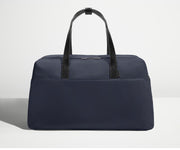 Front view of Away's Weekender duffle in Navy Blue with handles up