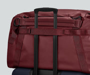 55L duffle bag secured to an Away suitcase by the trolley sleeve