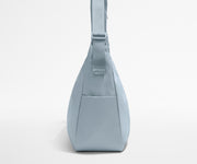 Side view of the Large Featherlight Crossbody showing the exterior bottle pocket