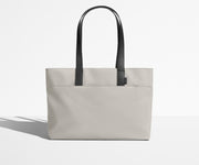 Front view of The Everywhere Tote with its leather handles up