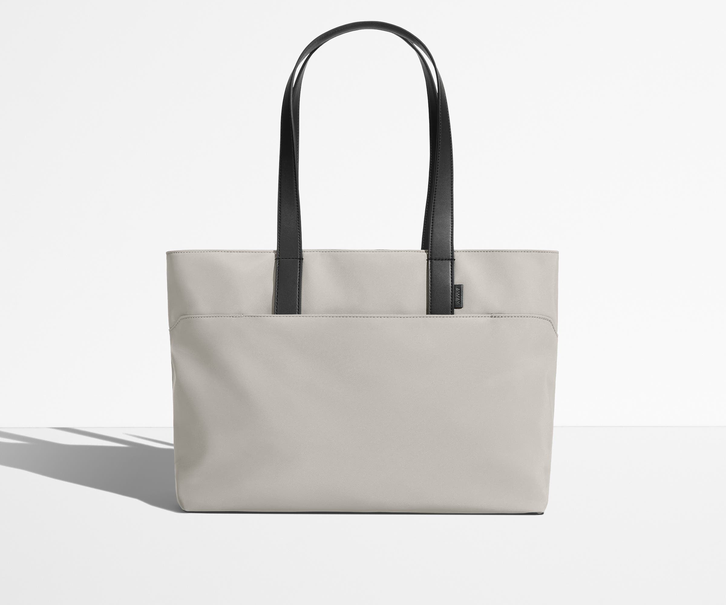 Front view of The Everywhere Tote with its leather handles up