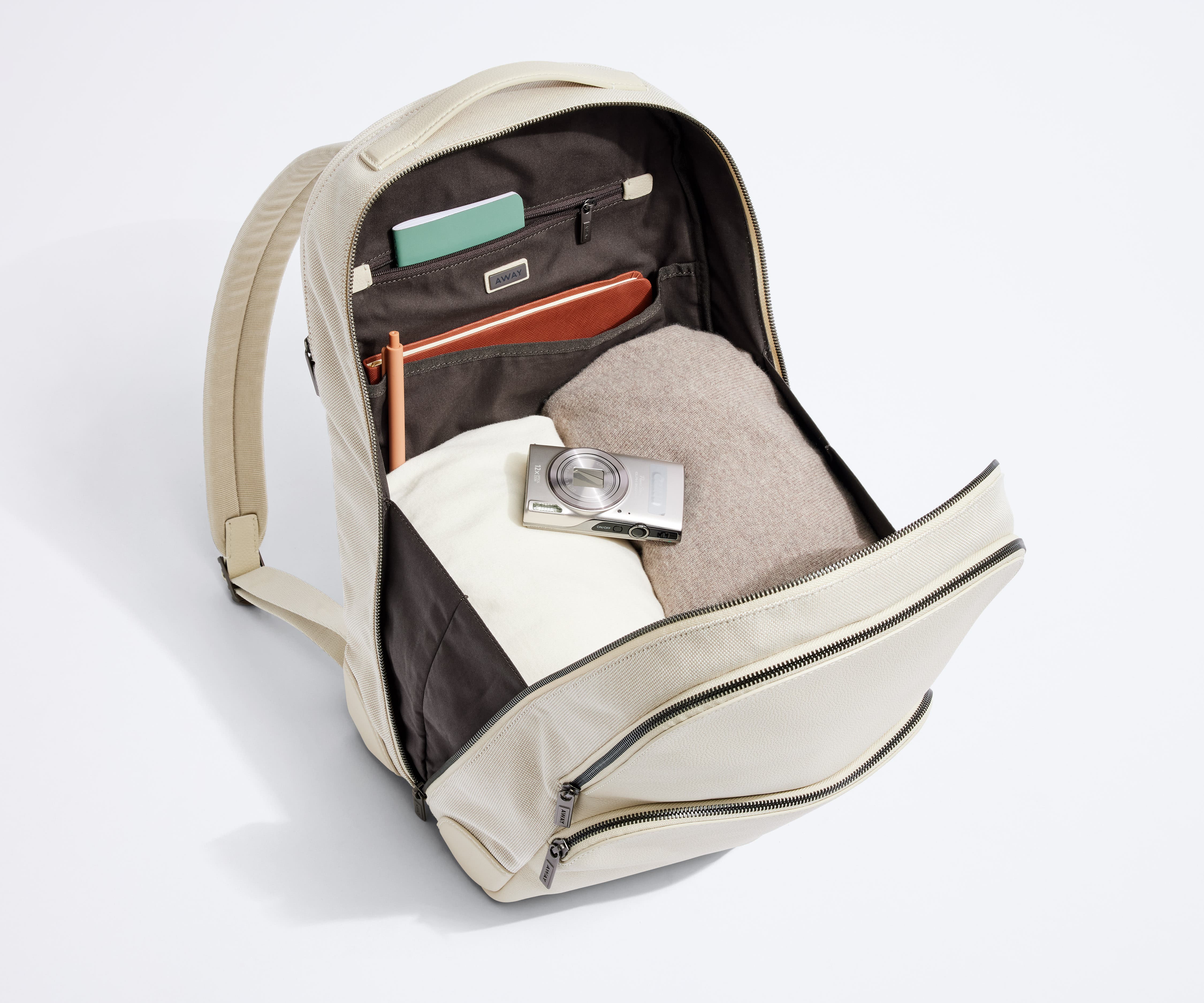 Interior organization of the main compartment with multiple zip and slip pockets. Packed with clothing, notebooks, and camera