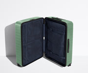 The Large suitcase in Sea Green shown open in an upright position to show interior organization and compression system