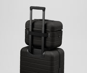 Train Case on top of an Away suitcase