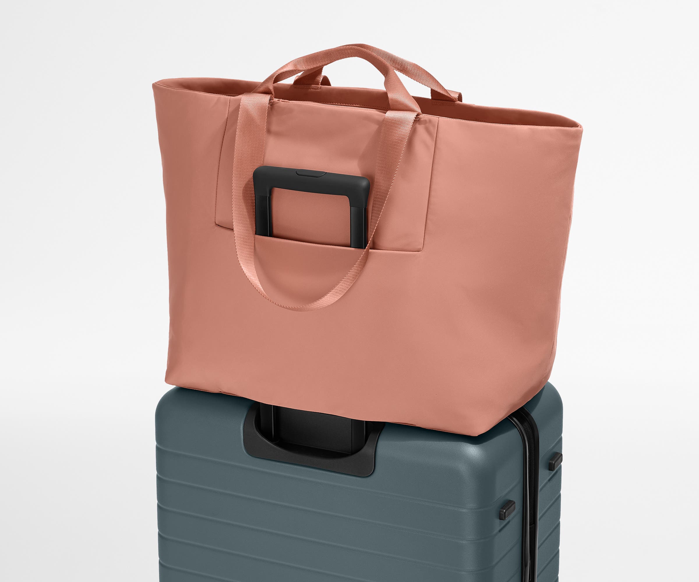 Large Featherlight Tote on top of a checked-size Away suitcase