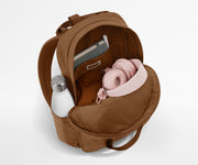 Featherlight Backpack packed with a sweater, notebook, headphones, and water bottle