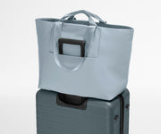 Large Featherlight Tote on top of a checked-size Away suitcase