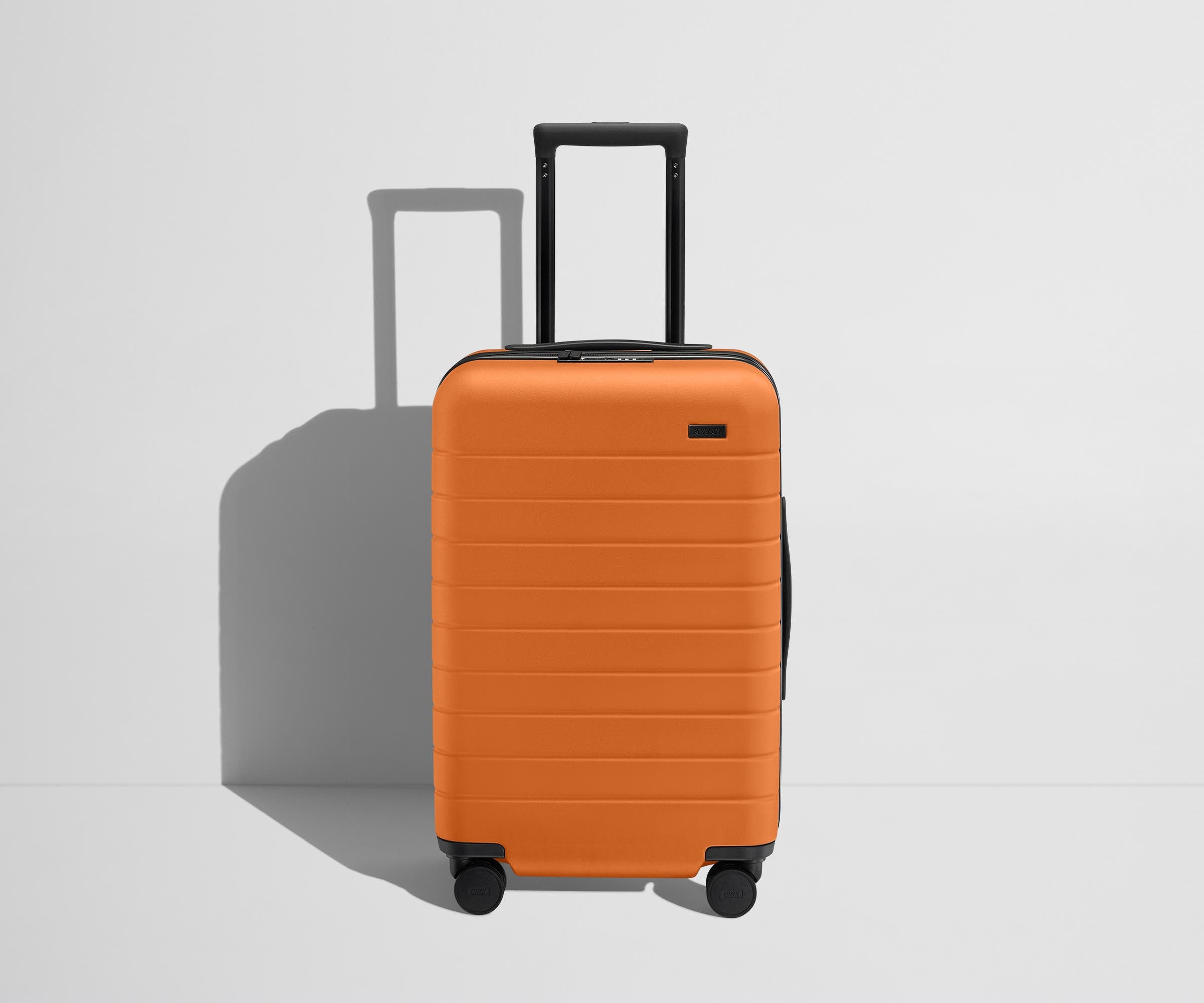 Front product view of The Carry-On Flex suitcase in Sorbet Orange with raised handle