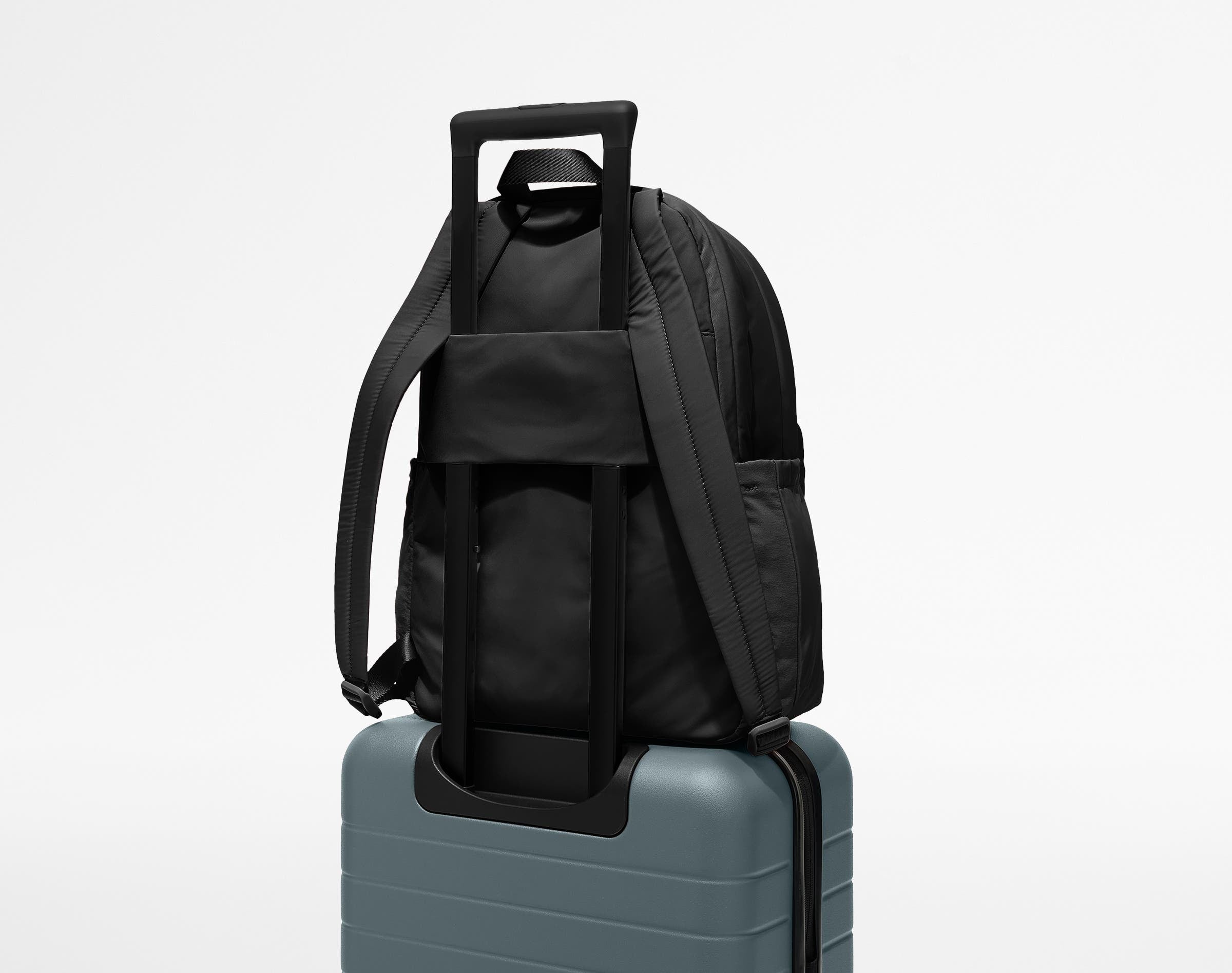 Large Featherlight Backpack on top of an Away suitcase