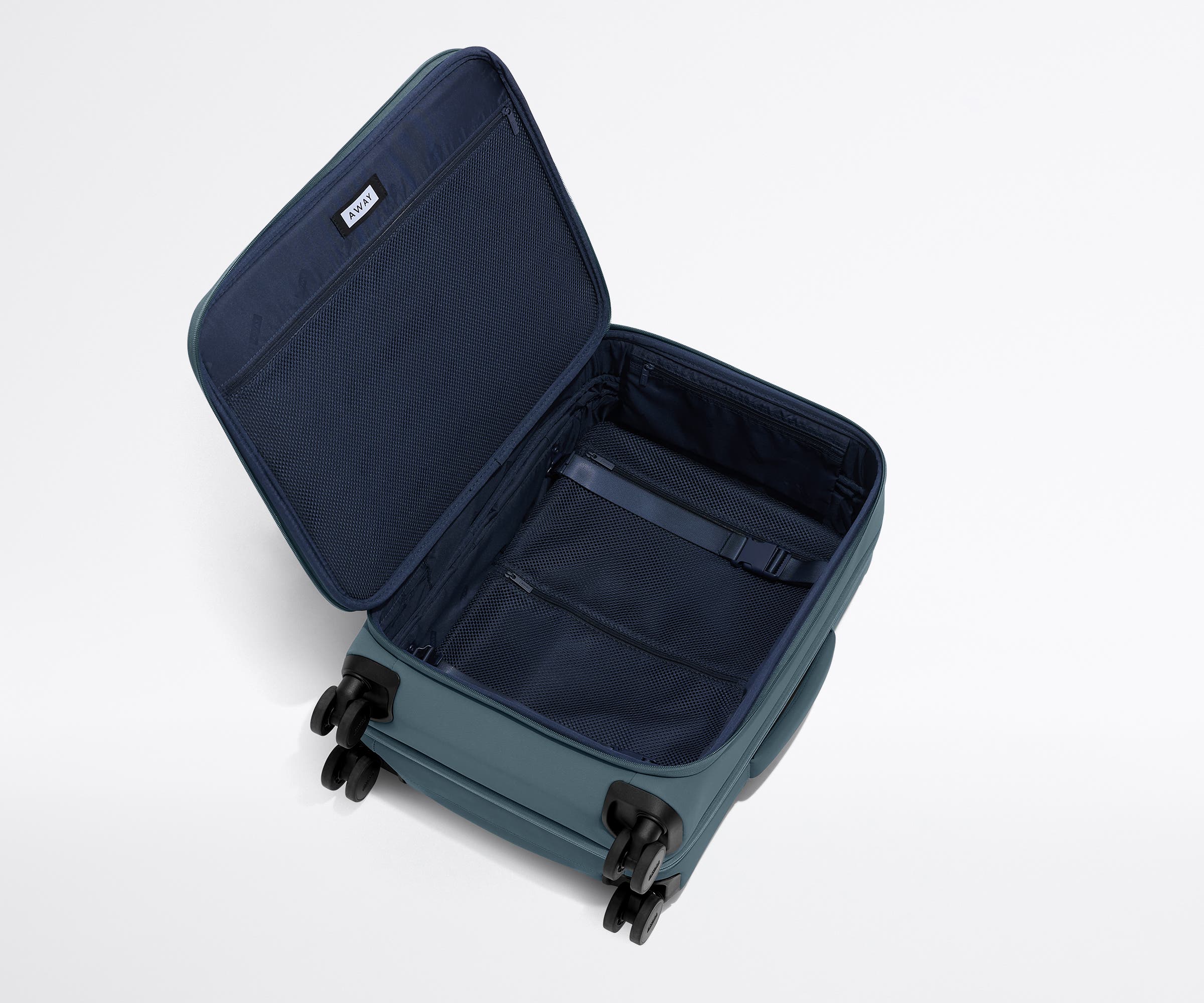 Open, unpacked Softside Bigger Carry-On, showing the depth of the bag and signature compression pad feature