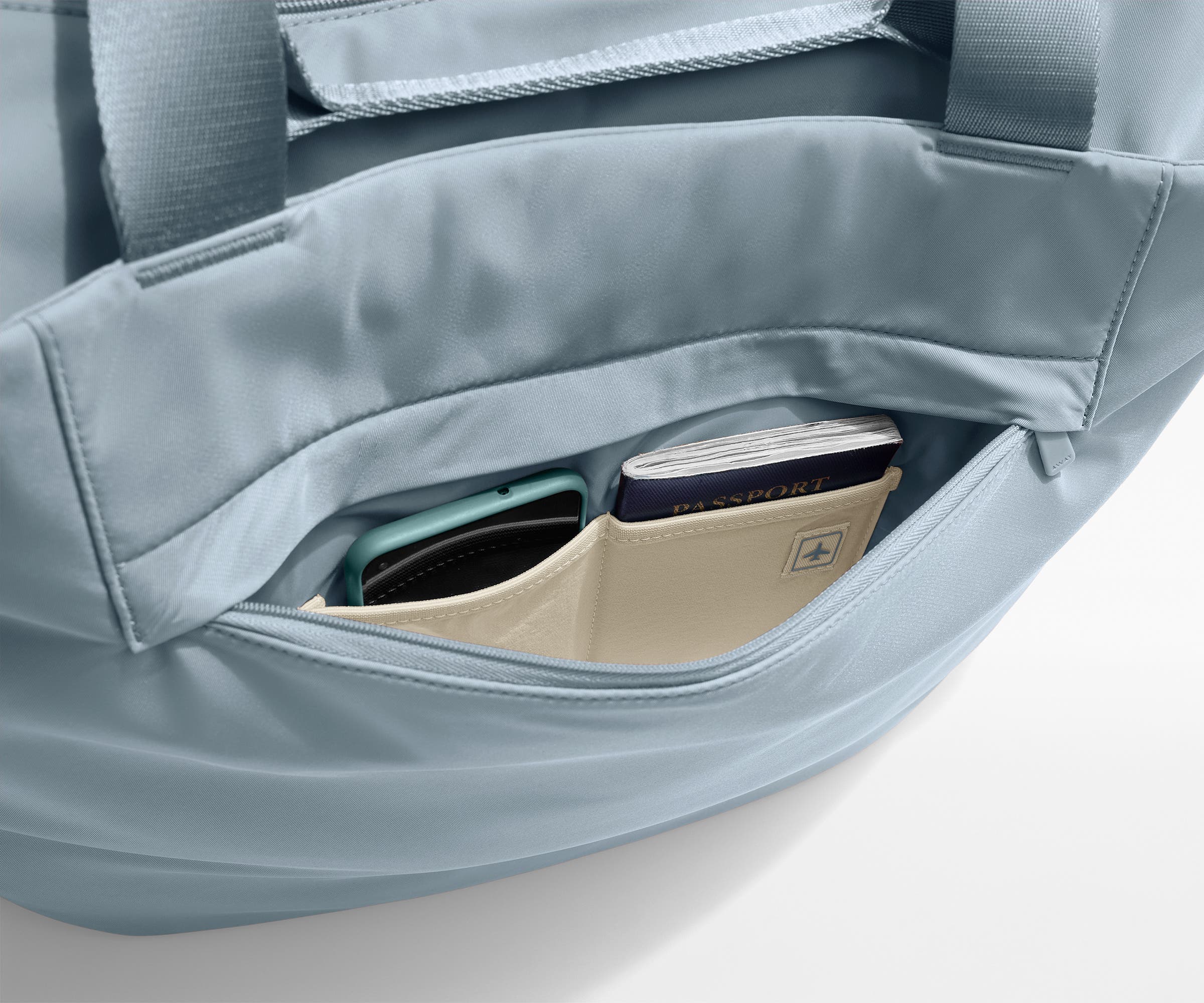 Phone and passport packed in an exterior zip pocket