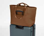Large Featherlight Tote on top of a checked-size Away suitcase