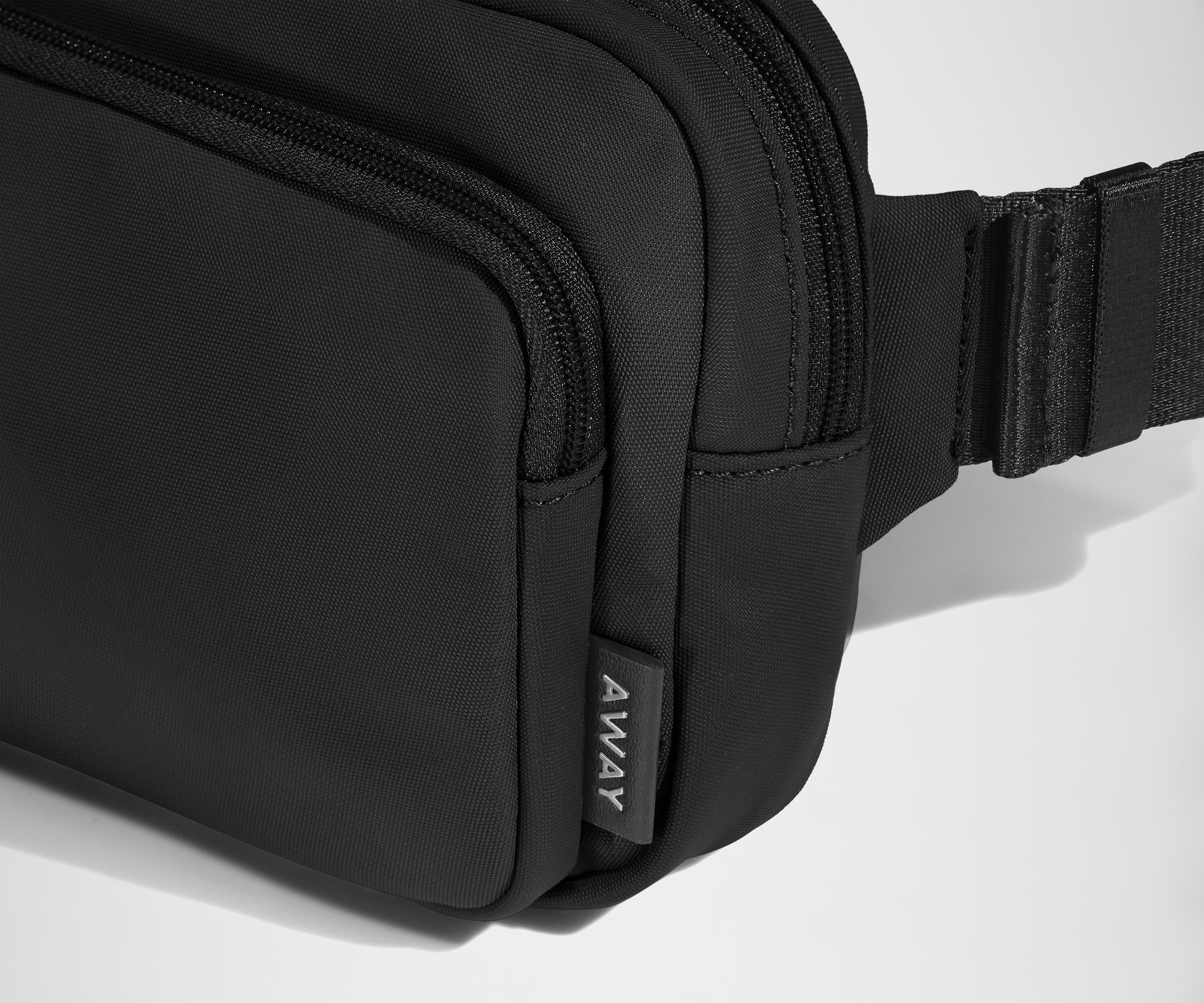 Detailed view of The Small Everywhere Sling Bag and Away logo