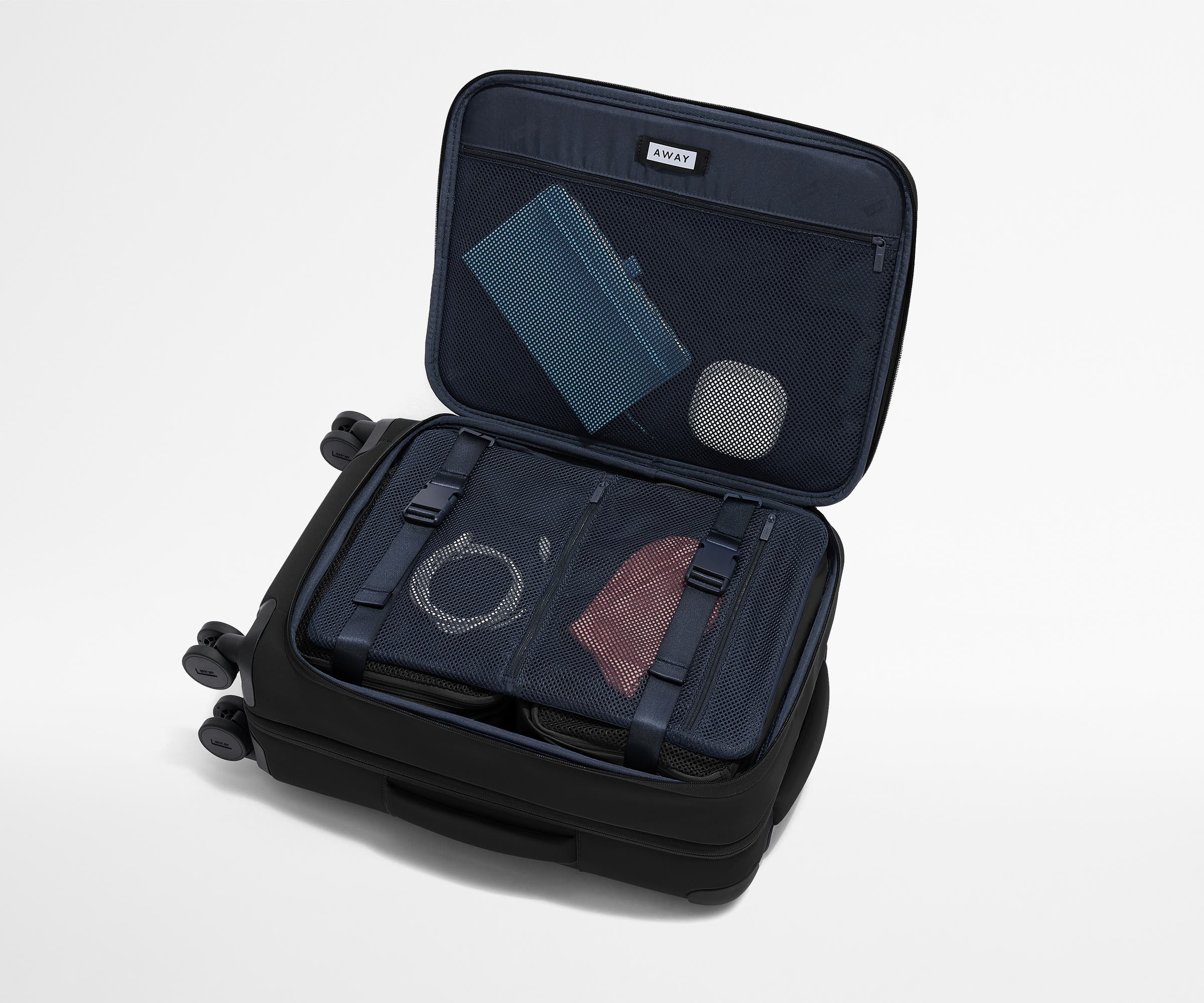 Open Softside suitcase, with travel essentials in the front flap pocket and compression pad pockets