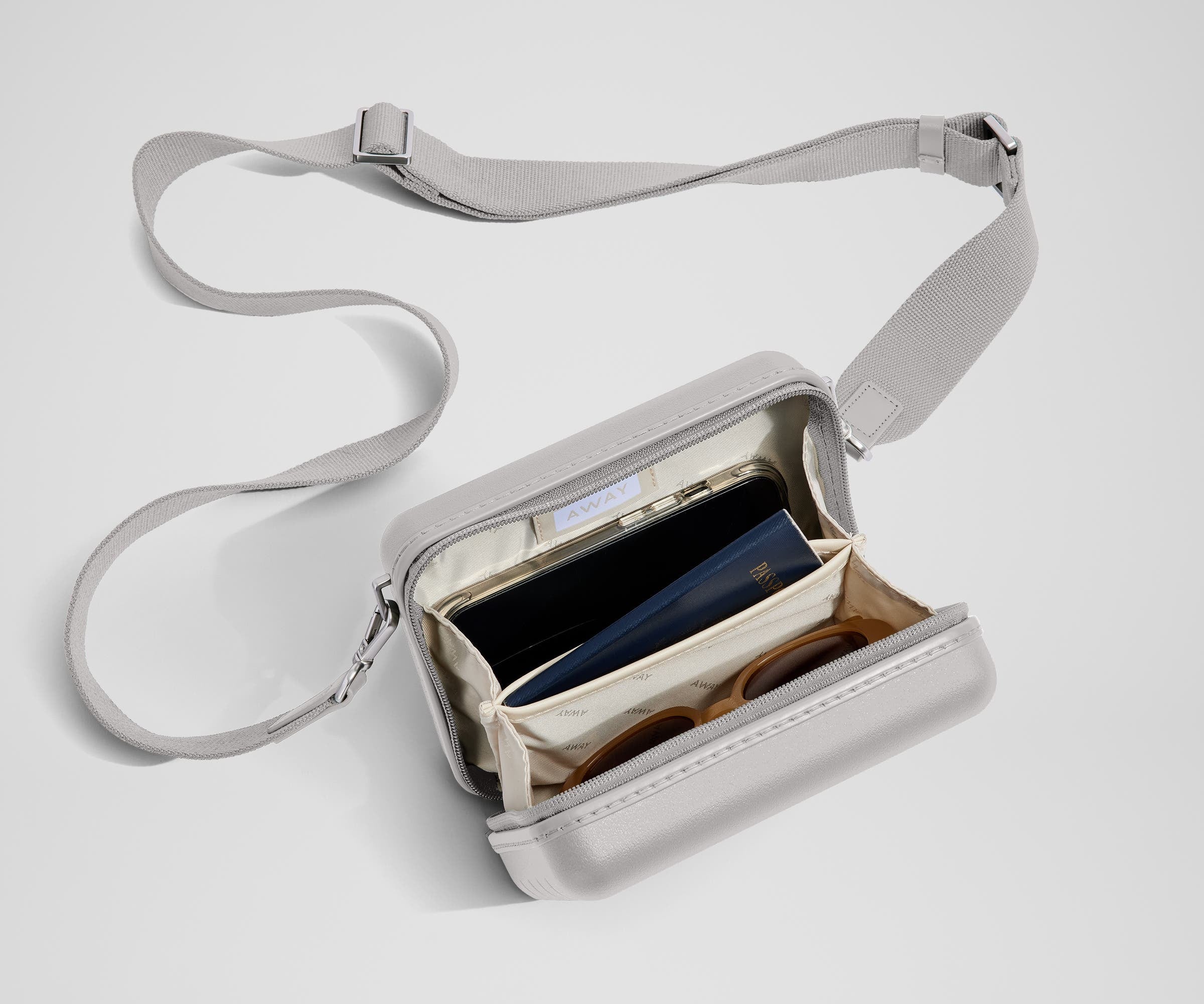 The Mini Crossbody packed with a phone, passport, and sunglasses