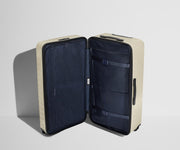 The Trunk suitcase in Salt White (Gloss) shown open in an upright position to show interior organization and compression system