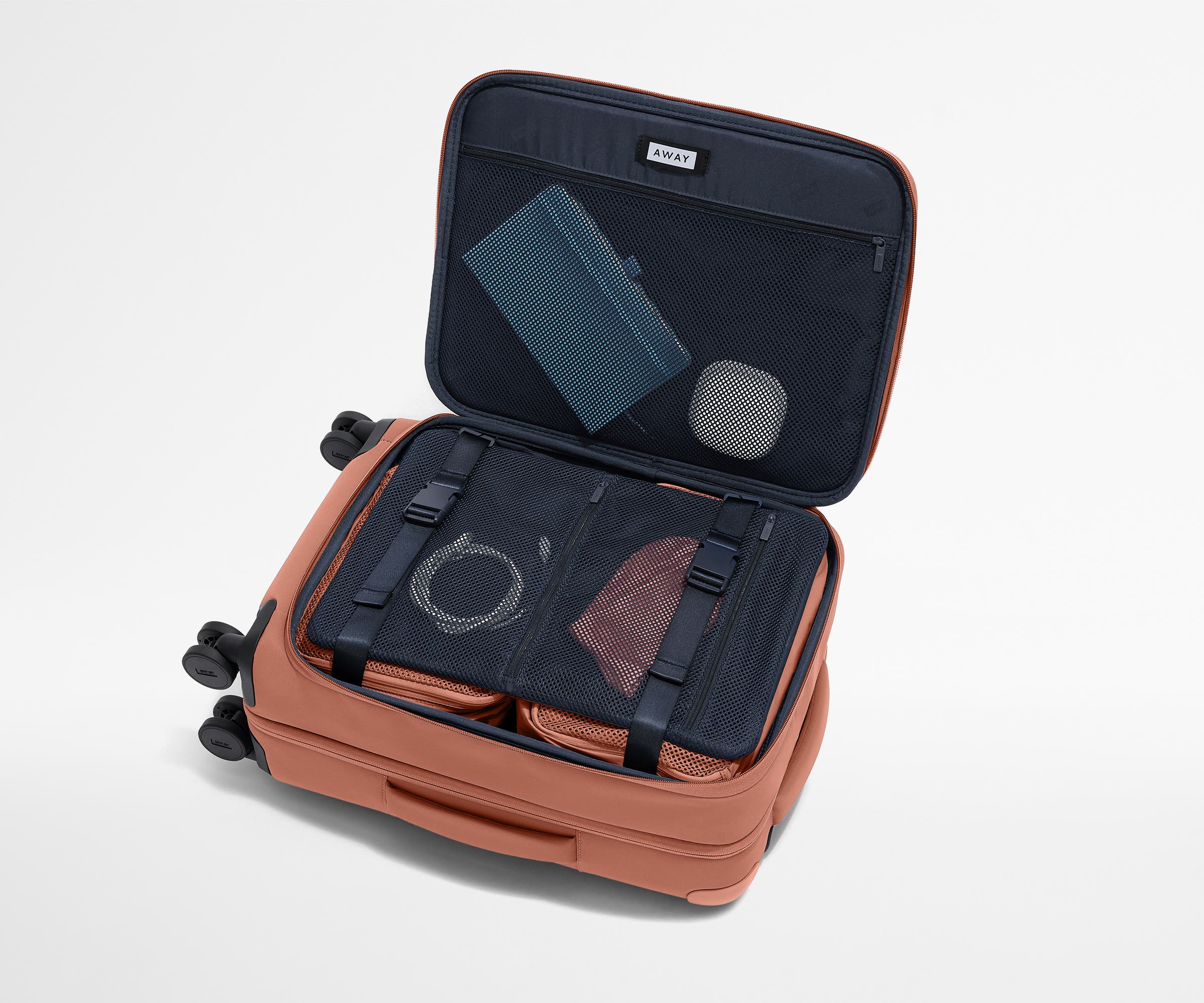 Open Softside suitcase, with travel essentials in the front flap pocket and compression pad pockets