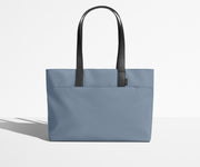 Front view of The Everywhere Tote with its leather handles up