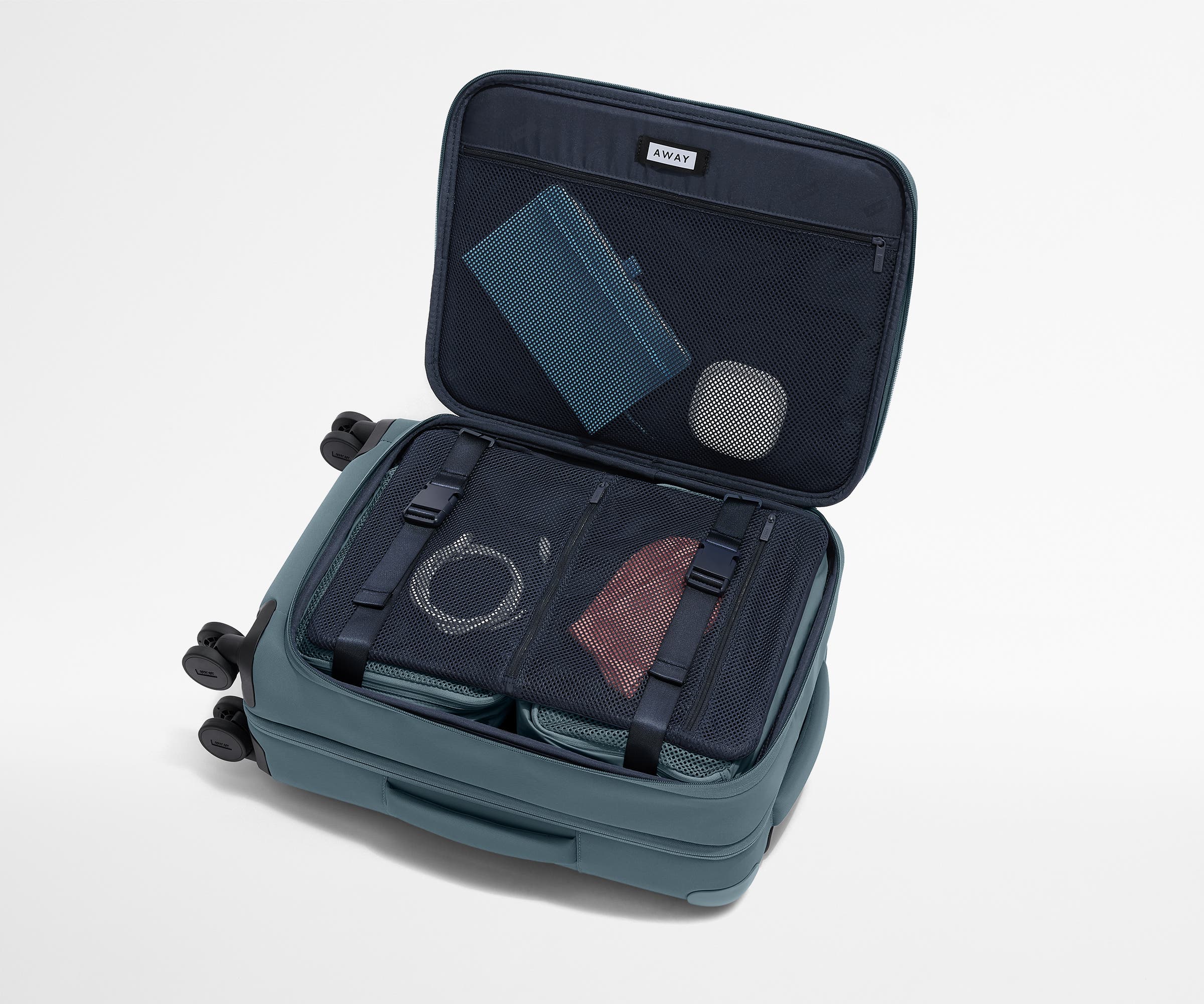 Open Softside suitcase, with travel essentials in the front flap pocket and compression pad pockets