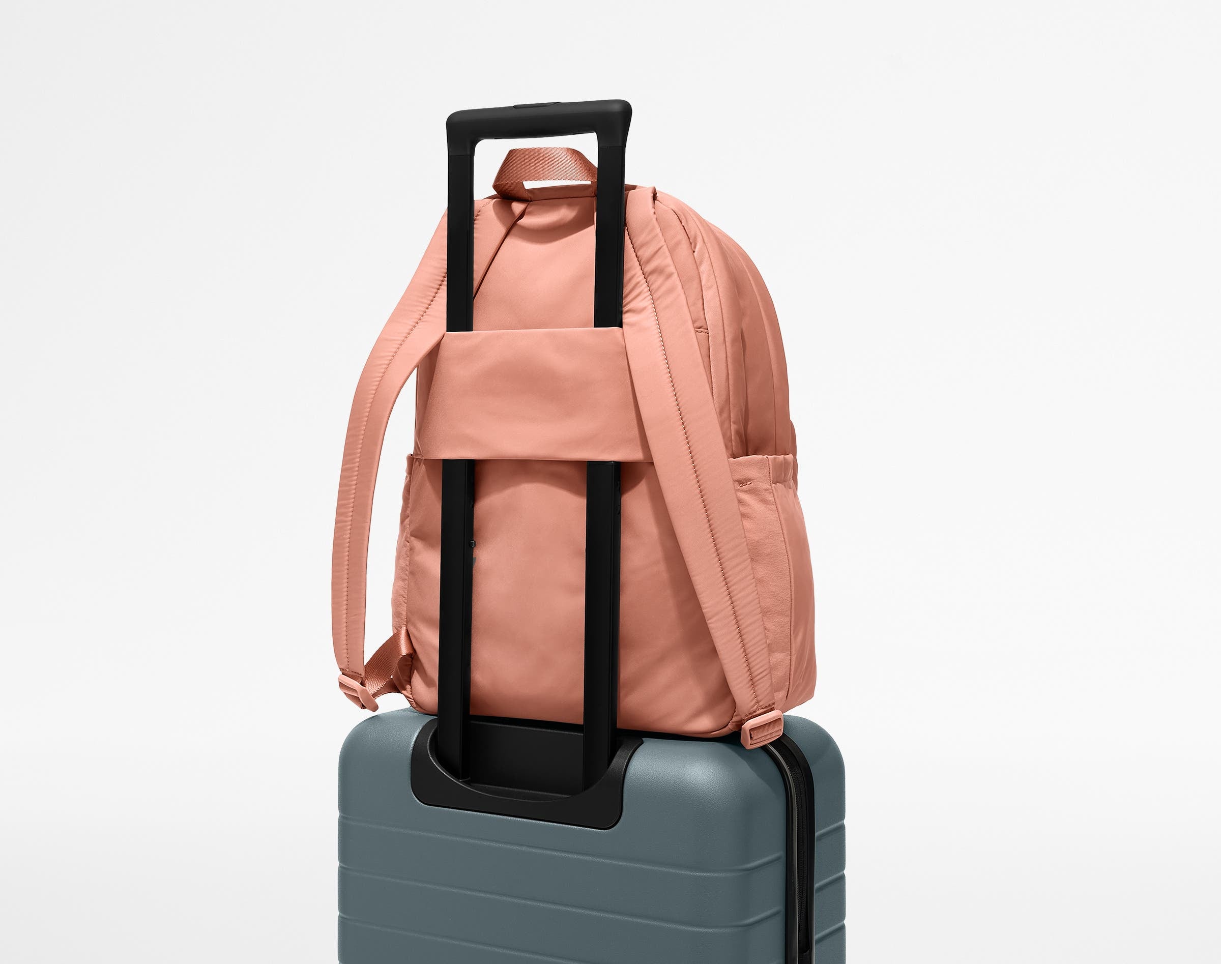 Large Featherlight Backpack on top of an Away suitcase