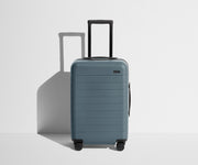 Front product view of The Carry-On suitcase in Coast Blue with raised handle