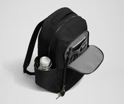 Front exterior zip pocket, detachable key clip, and exterior water bottle pocket of The Commuter Backpack