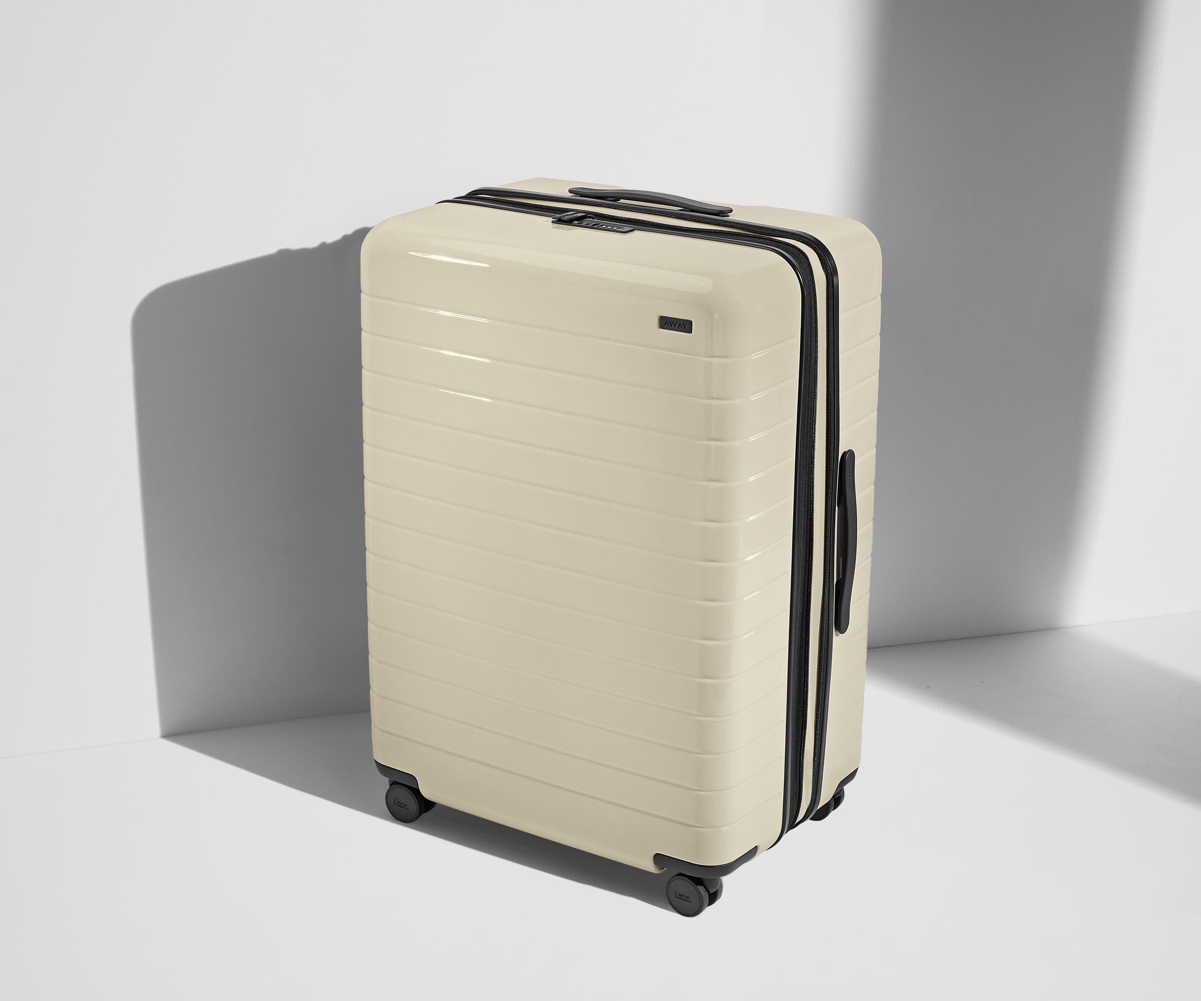 Angled product view of The Large Flex suitcase in Salt White (Gloss)