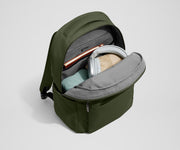 Main compartment of the Commuter Backpack packed with a notebook, light layers, and headphones