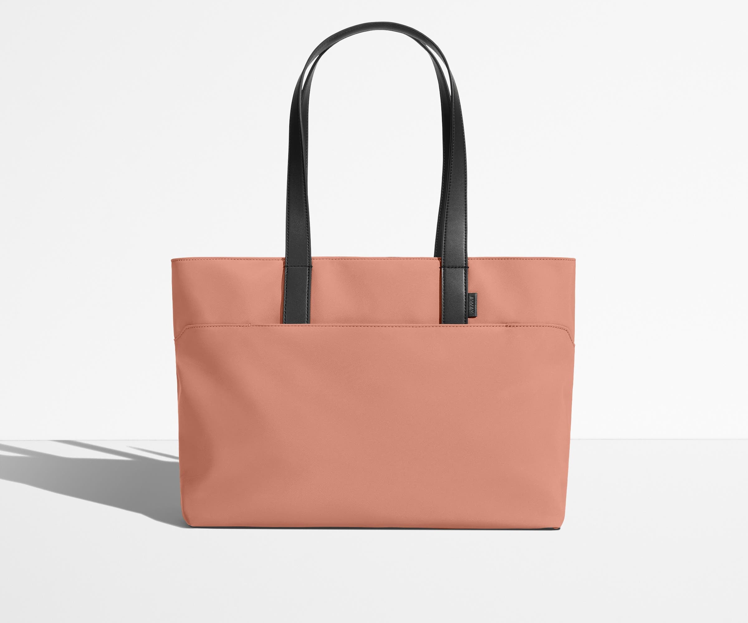 Front view of The Everywhere Tote with its leather handles up