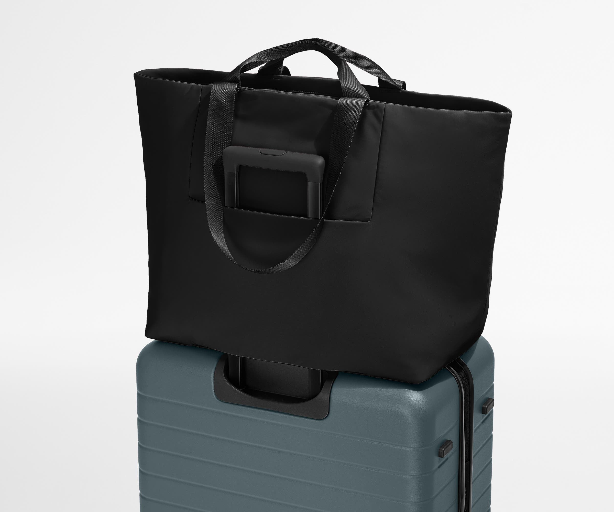 Large Featherlight Tote on top of a checked-size Away suitcase