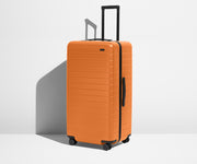 Angled product view of The Trunk suitcase in Sorbet Orange
