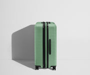 Side product view of The Medium Flex suitcase in Sea Green shown fully expanded