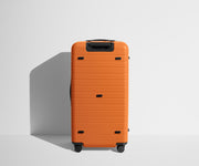 Back product view of The Trunk suitcase in Sorbet Orange