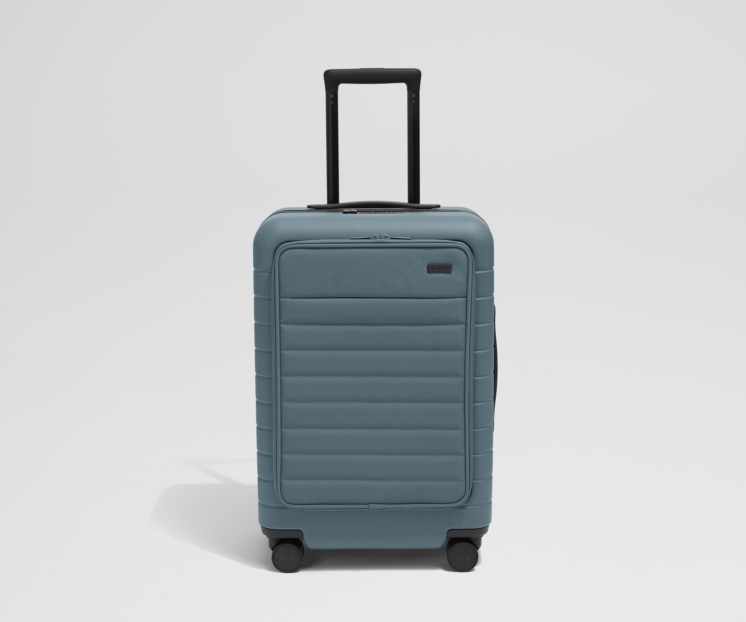 Front product view of The Front Pocket Bigger Carry-On suitcase in Coast Blue with raised handle
