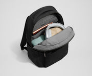 Main compartment of the Commuter Backpack packed with a notebook, light layers, and headphones