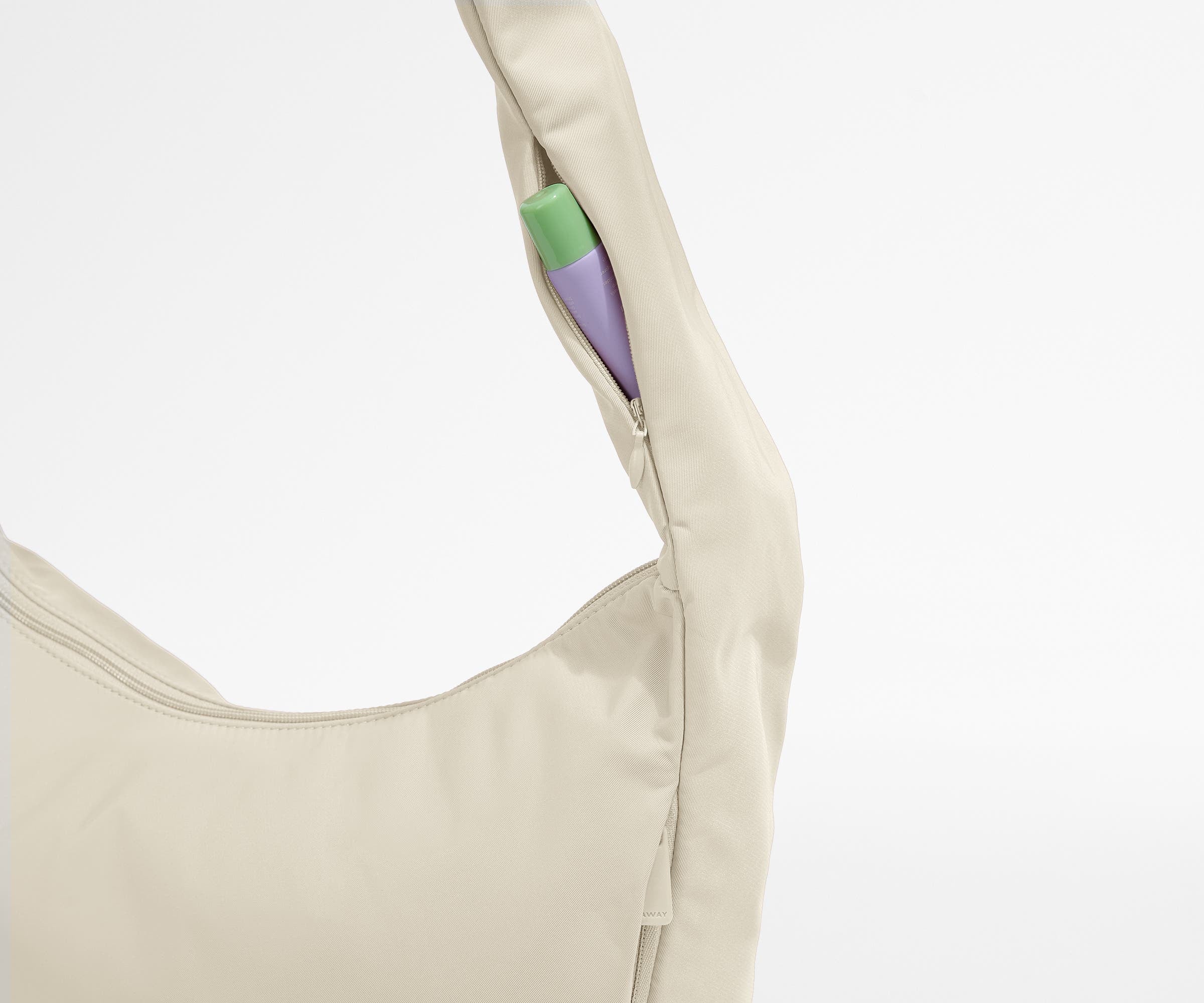 Chapstick in the discreet, zippered strap pocket