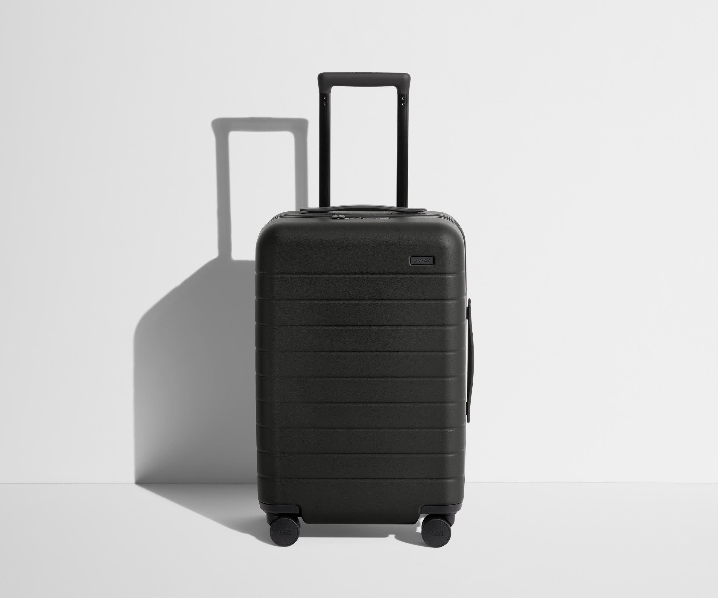 Front product view of The Carry-On suitcase in Jet Black with raised handle