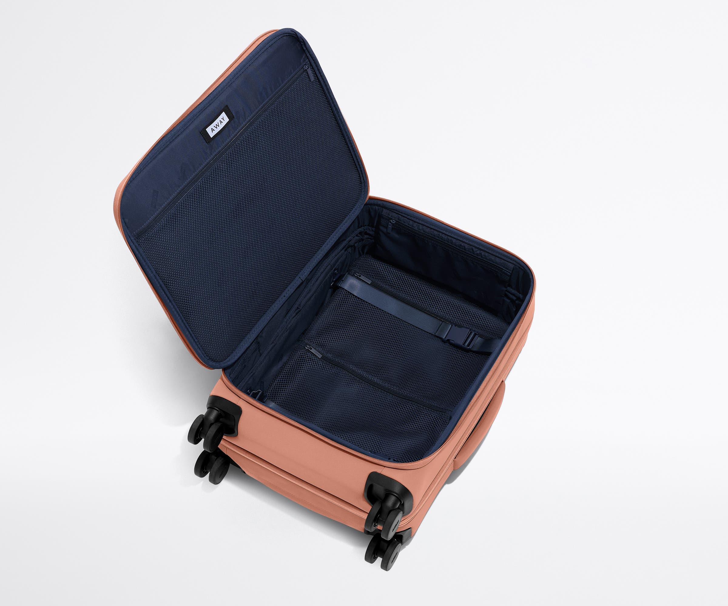 Open, unpacked Softside Bigger Carry-On, showing the depth of the bag and signature compression pad feature