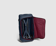 85L Duffle standing upright and unzipped, showing the compression straps and interior pockets