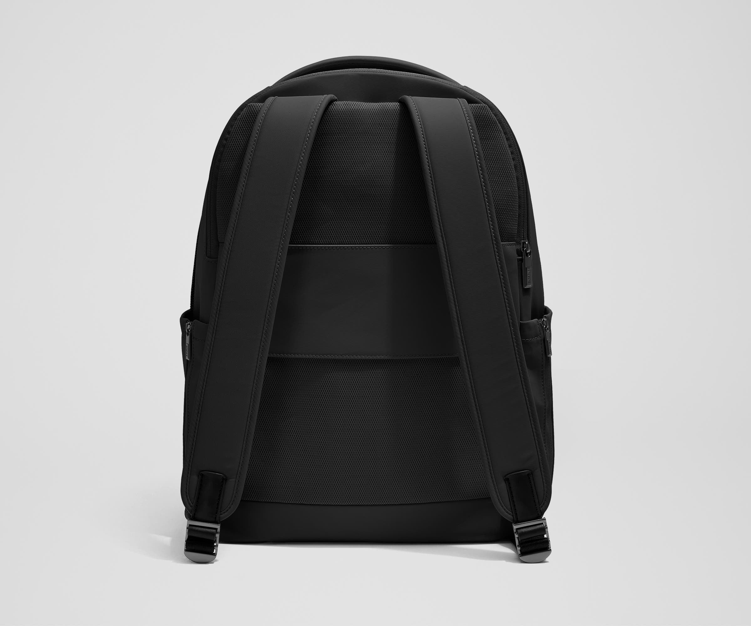 The Commuter Backpack back view showing padded shoulder straps and trolley sleeve feature