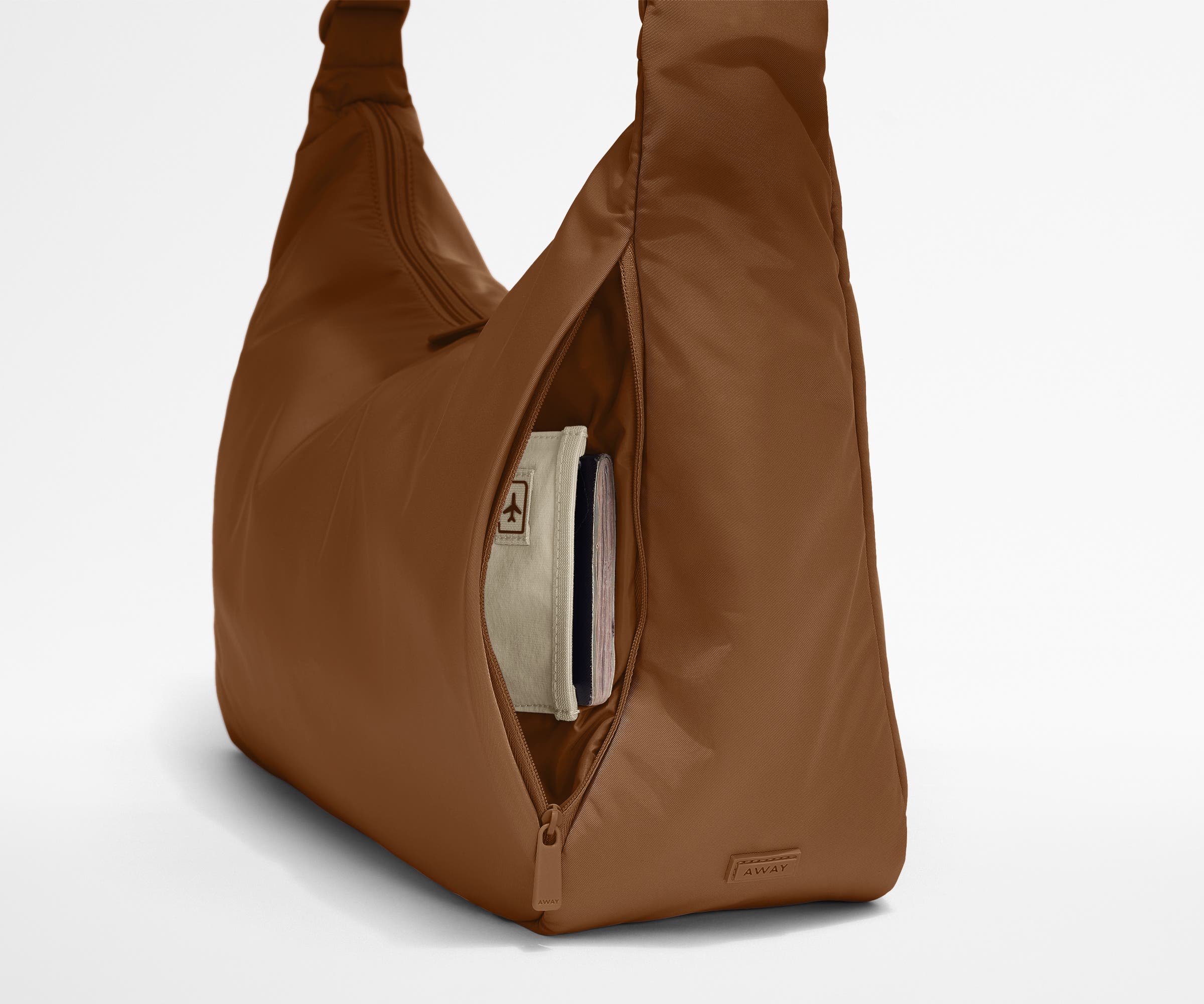 Passport shown in the travel-ready pocket in the front zippered pocket