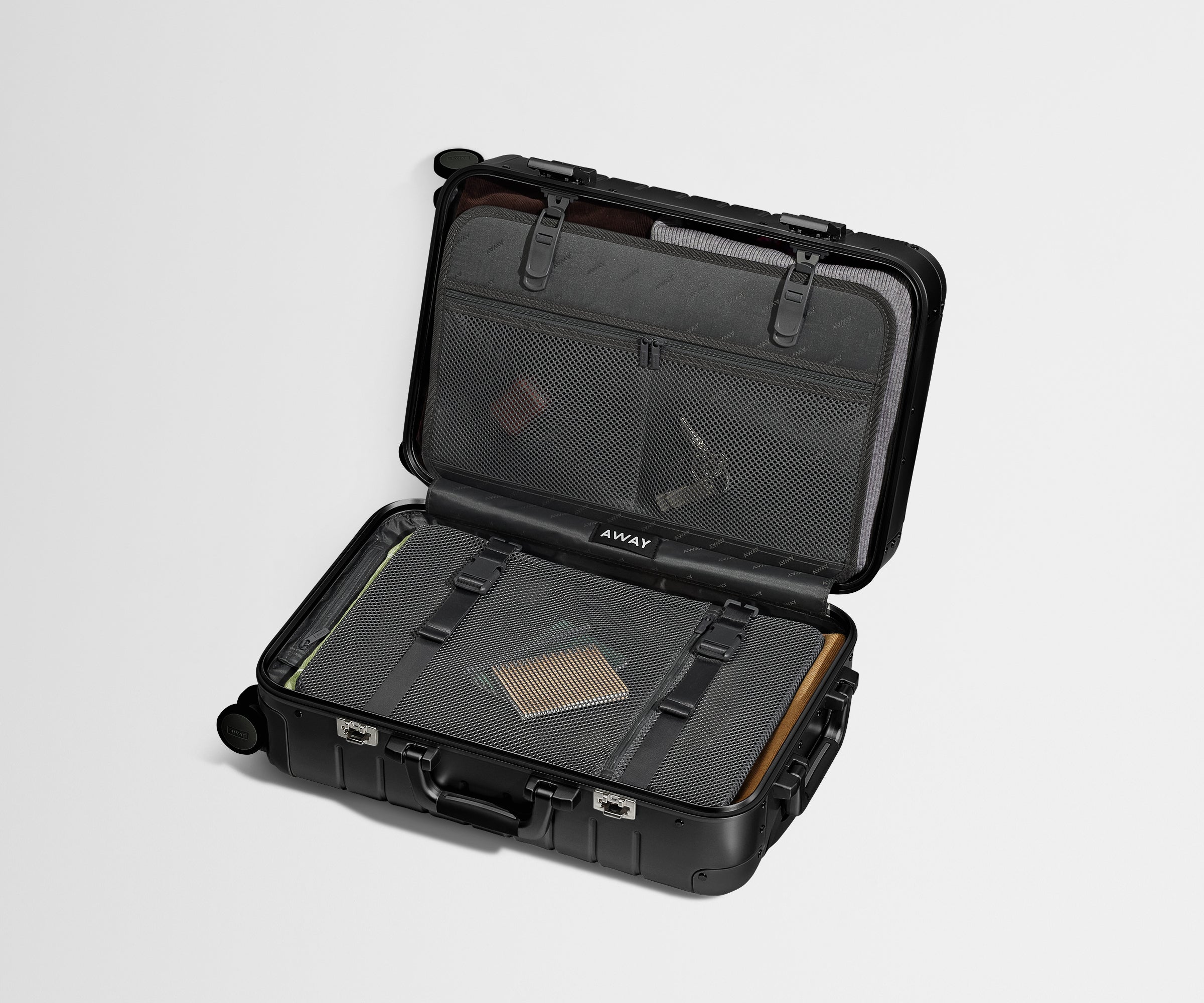 Open, packed Aluminum Carry-On showing the compression pad system and interior organization