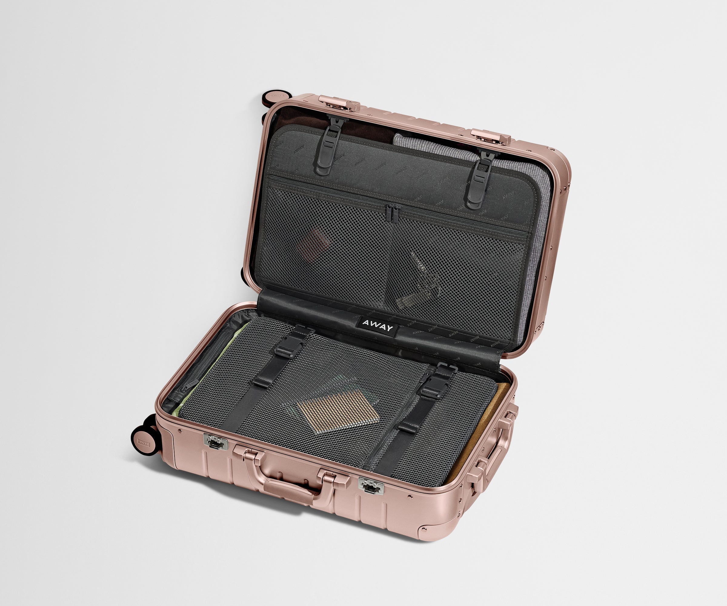 Packed Aluminum Carry-On showing the interior organization system and compression pad