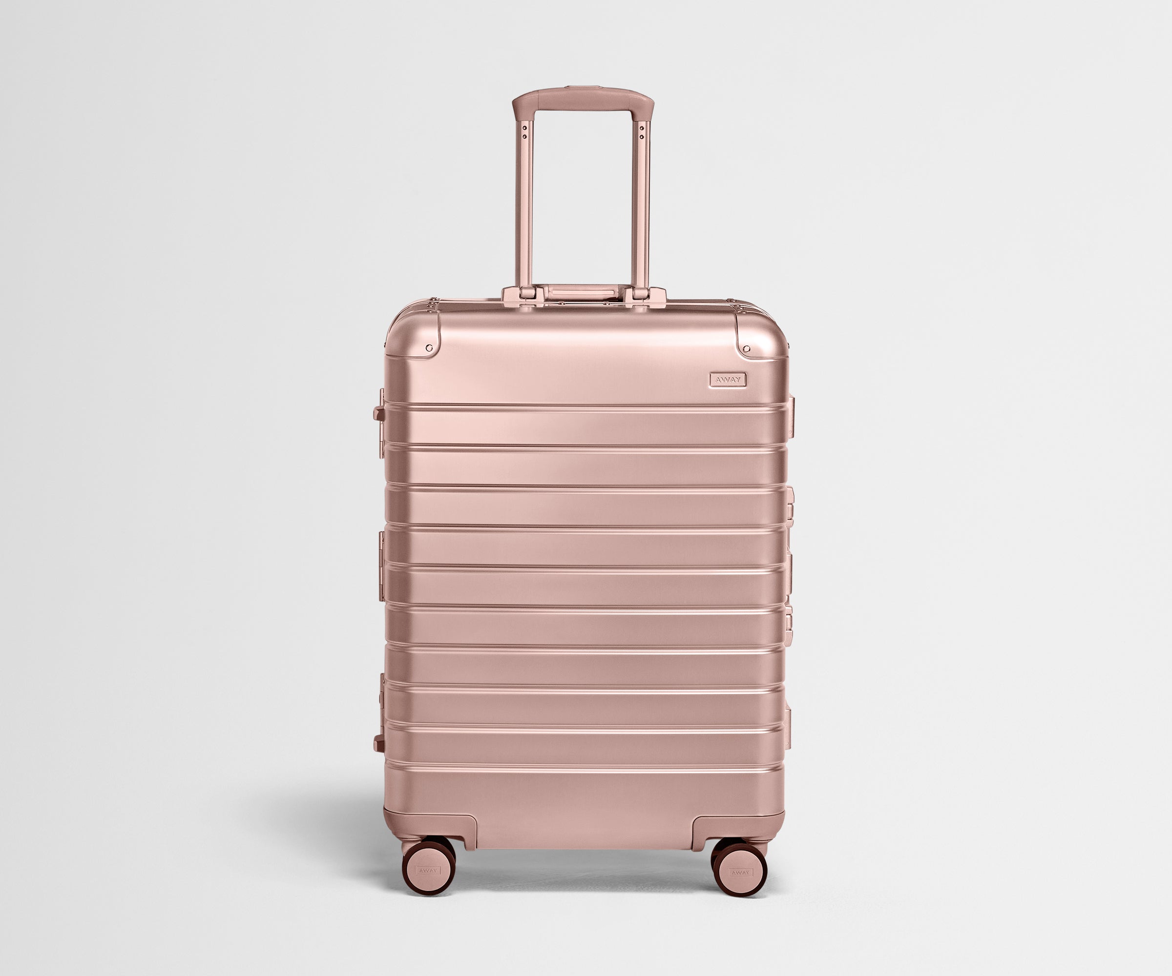 Front view of the Medium: Aluminum suitcase in Rose Gold with handles raised